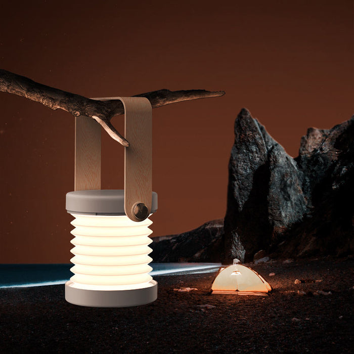 Folding lantern lamp open on a bedside table