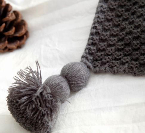 Knit throw with fringed ends on a sofa