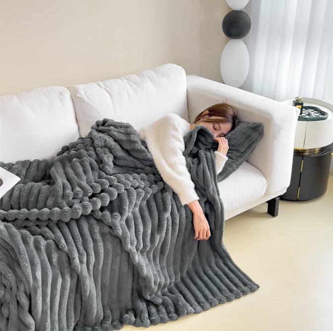 Bubble Plush Throw in dark grey on a white sofa