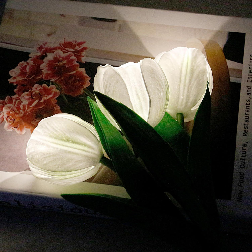 Close view of the white tulip lamp, lit