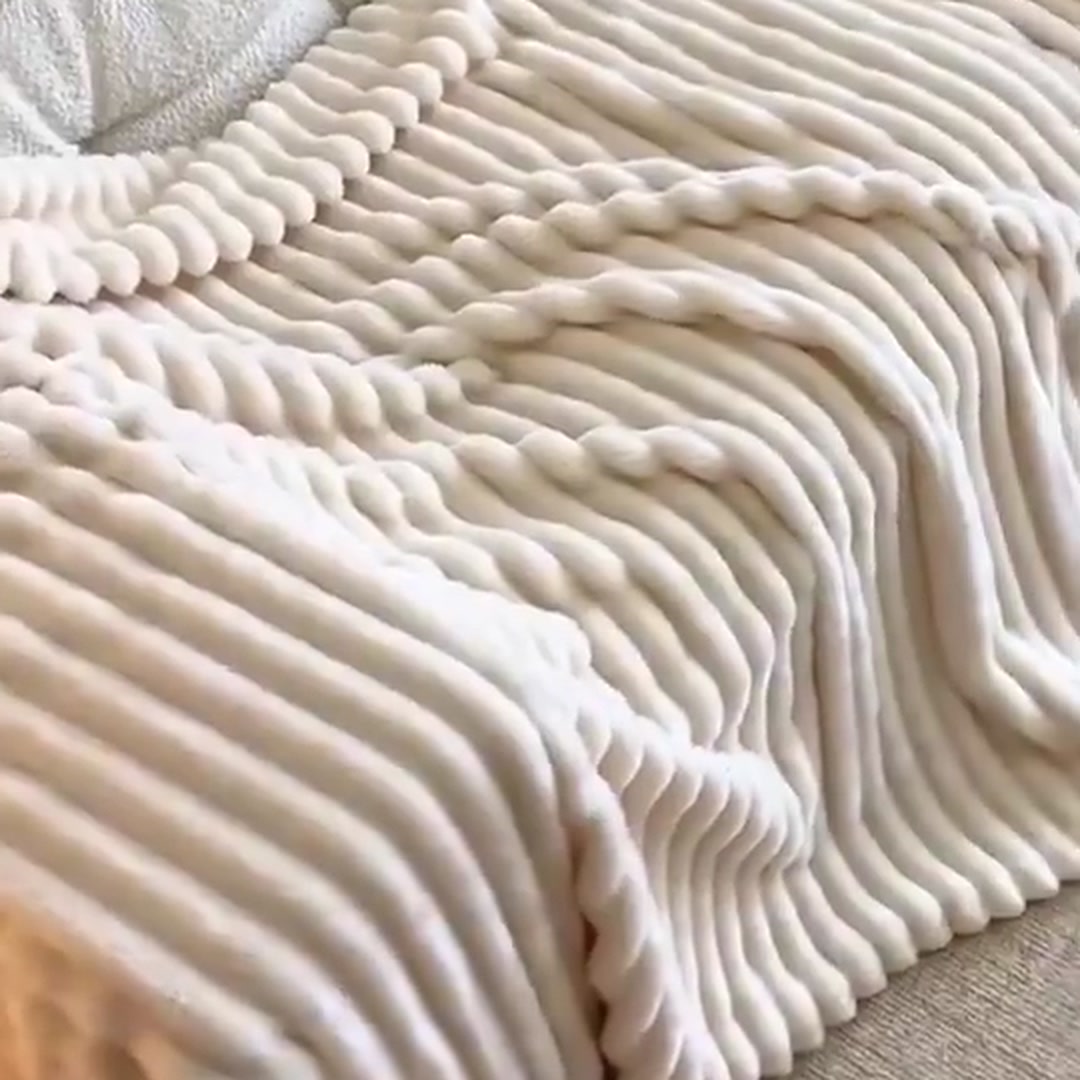 Bubble Plush Throw in milky white spread flat, showing the ribbed pattern