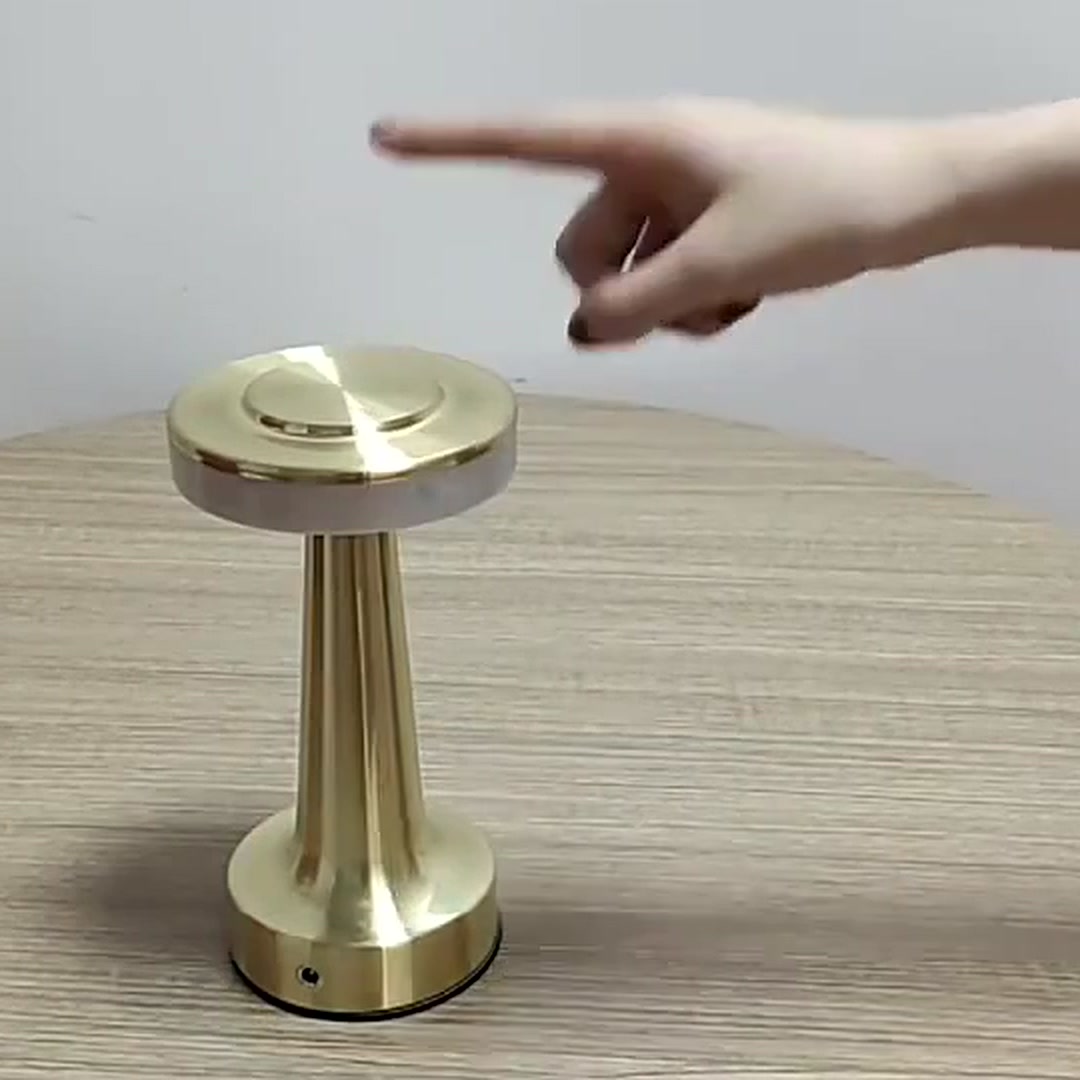 Cordless Table Lamp in gold on a wooden table