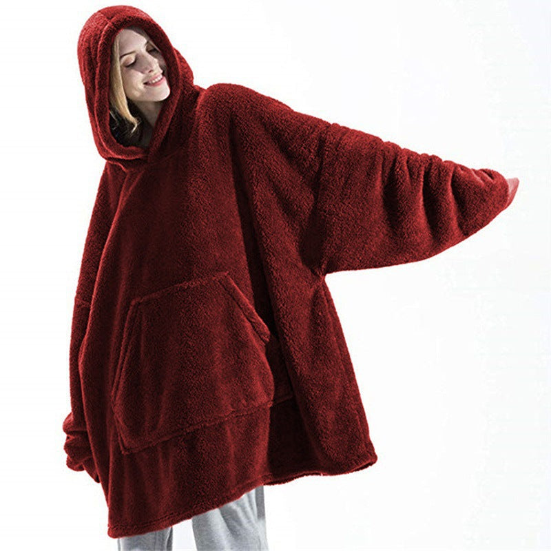 Wearable blanket hoodie in wine red, arms out to show the oversized cut