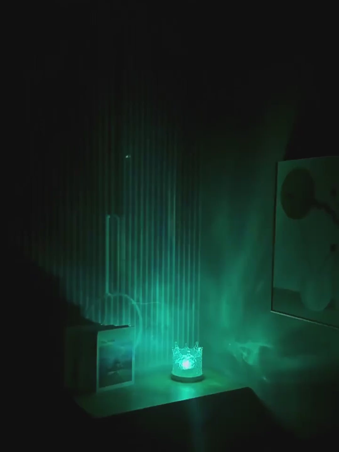 Crown water ripple lamp in a dark room, moving water light on the wall as it changes colour