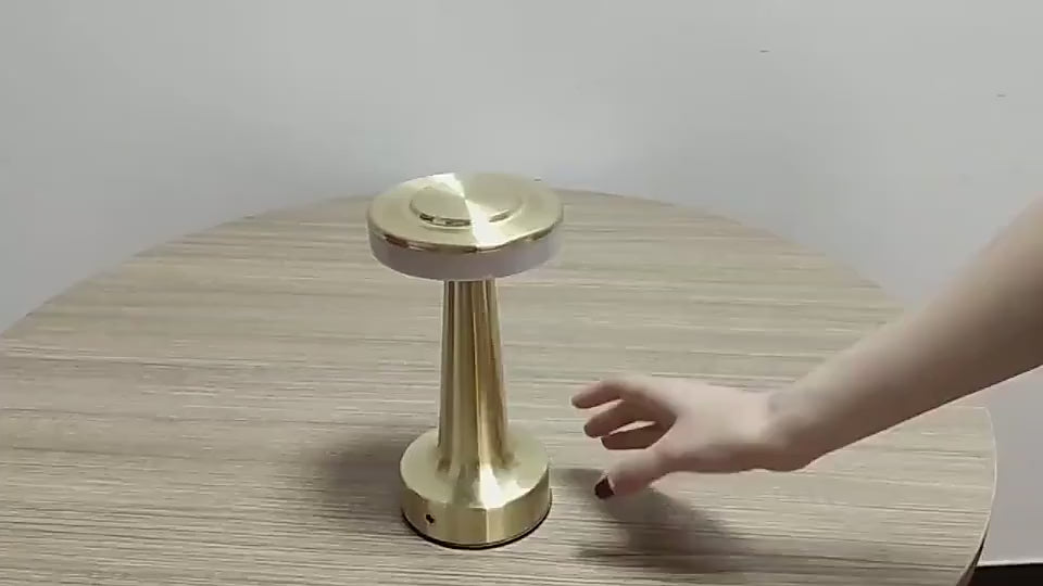 Cordless Table Lamp in gold being switched on and dimmed by touch