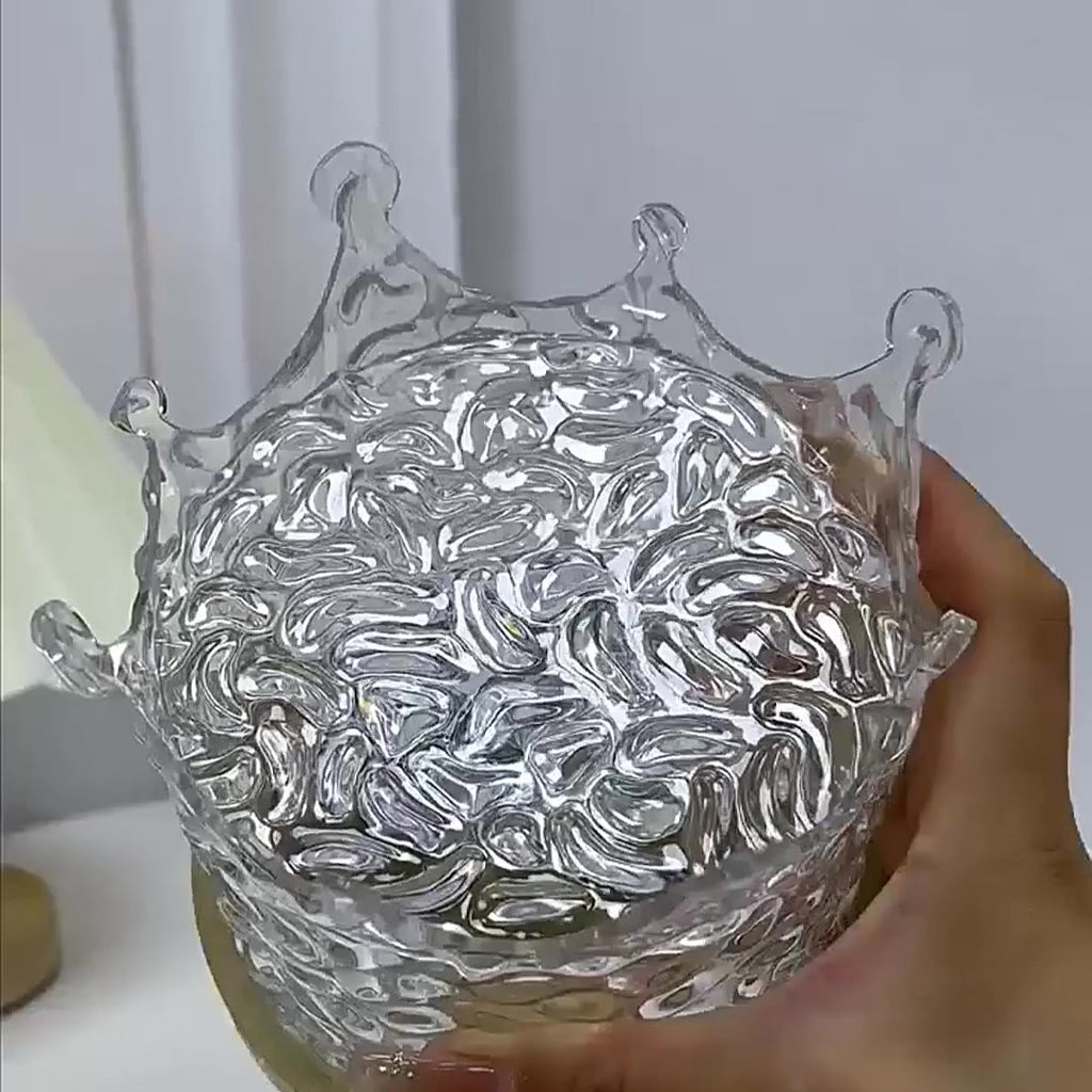 The crystal crown top of the Water Ripple Lamp held in one hand